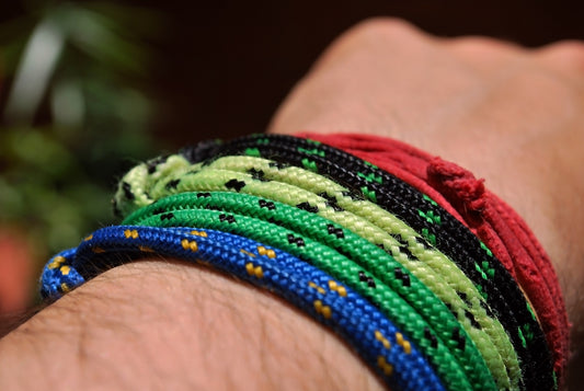 person wearing assorted color cord bracelets