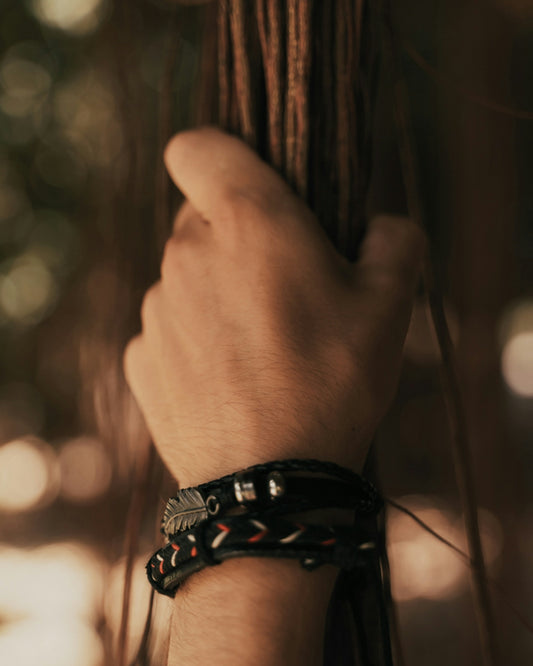 person wearing black and silver bracelet