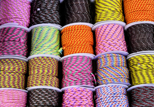 a bunch of different colored rope on a table