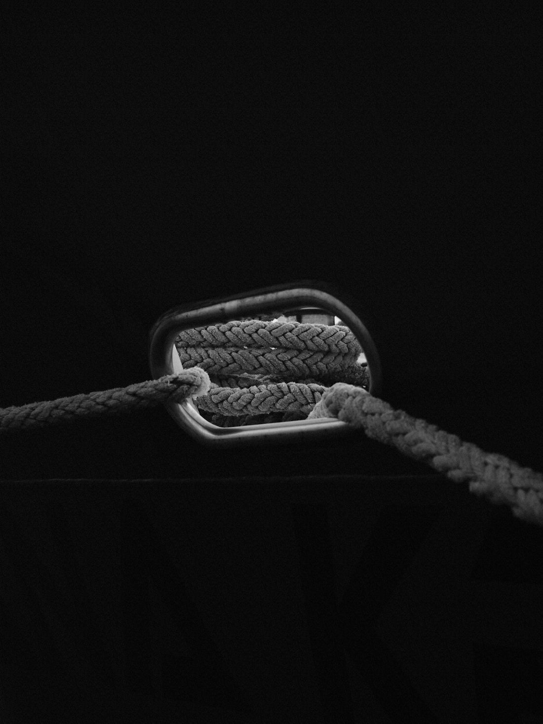 A black and white photo of a rope on a boat