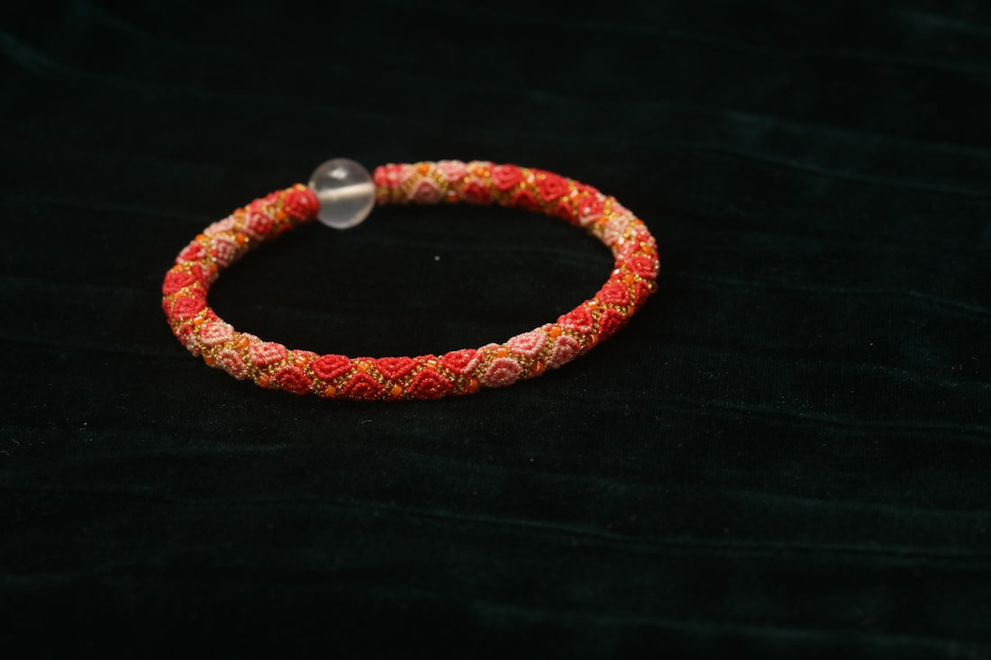 A beaded bracelet with a clear bead.