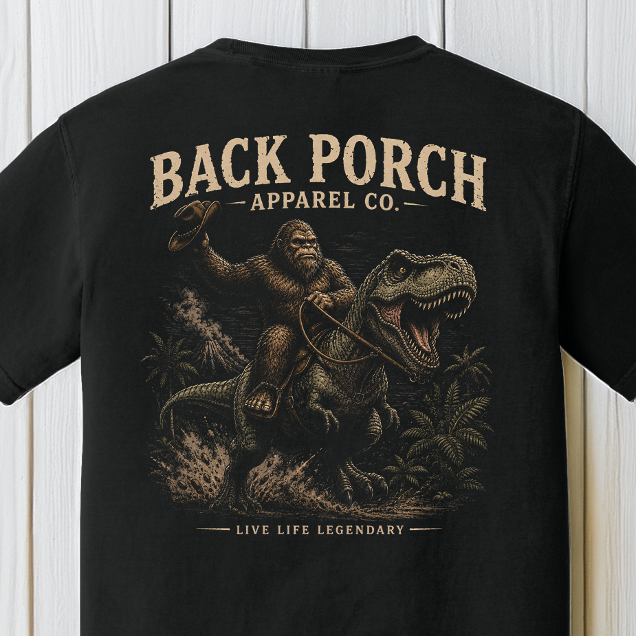 Back Porch Apparel Bigfoot Riding T-Rex Comfort Colors Graphic Tee