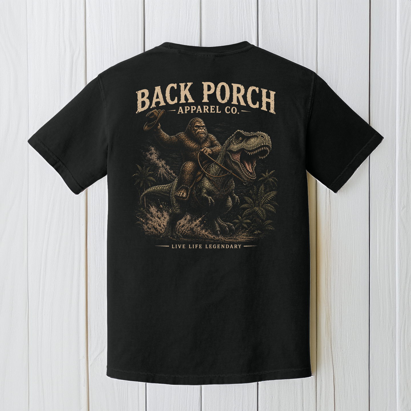 Back Porch Apparel Bigfoot Riding T-Rex Comfort Colors Graphic Tee